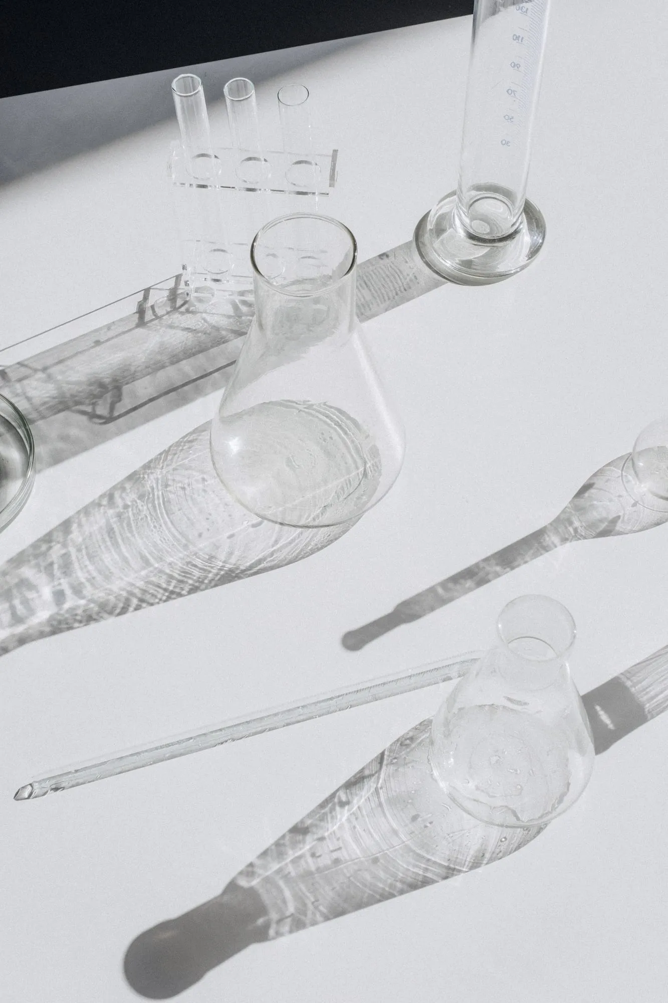 Clear laboratory glassware on a white surface